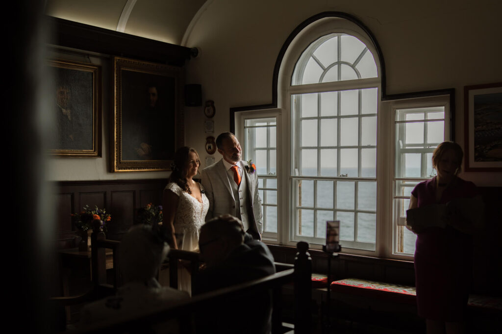 Bride and Groom getting married at Lyme Regis Guild Hall. Shot by Dorset, Devon and Cornwall Wedding Photographer, Chris Goddard